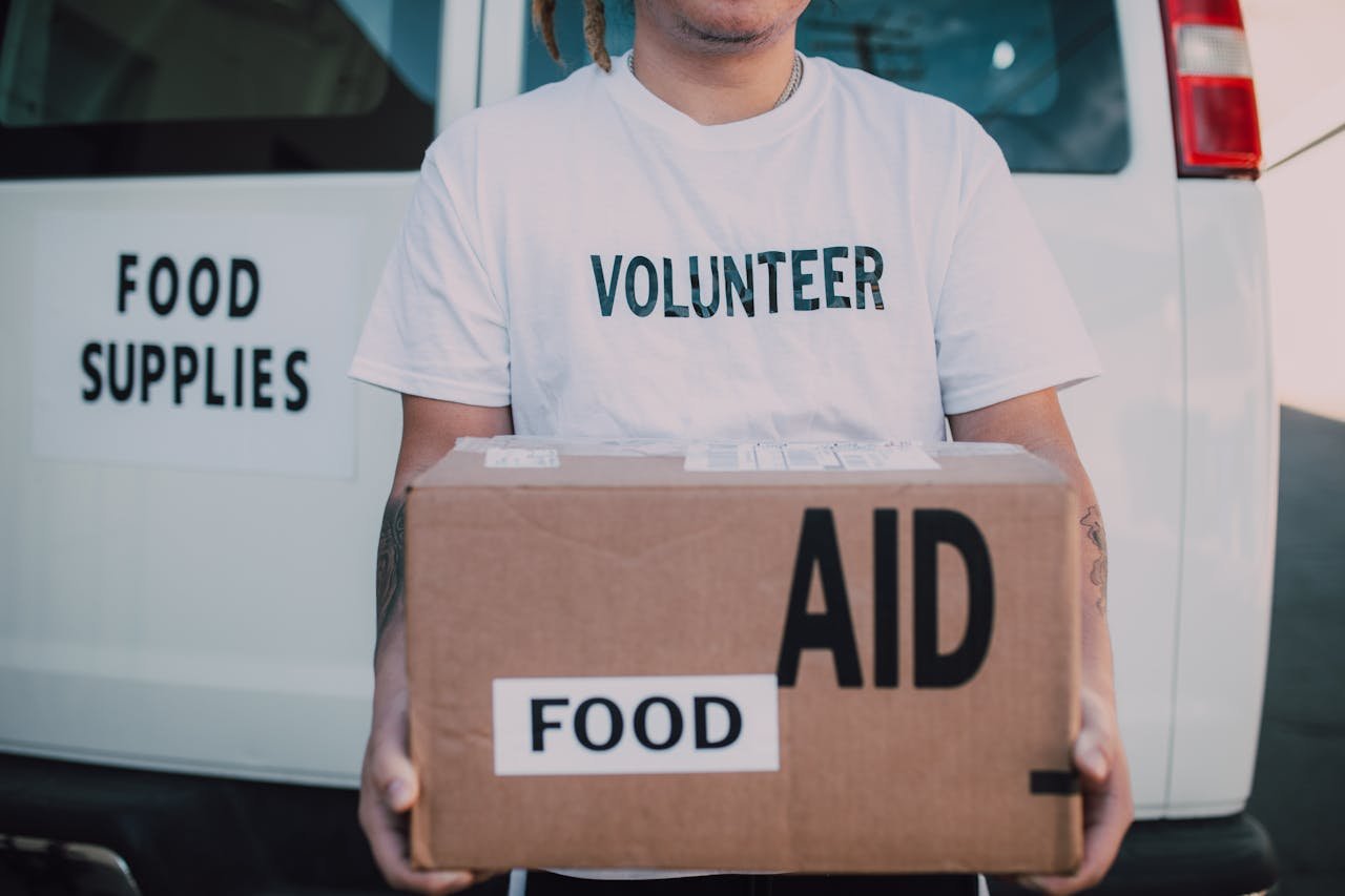 Humanitarian aid workers distributing supplies at a large nonprofit relief operation