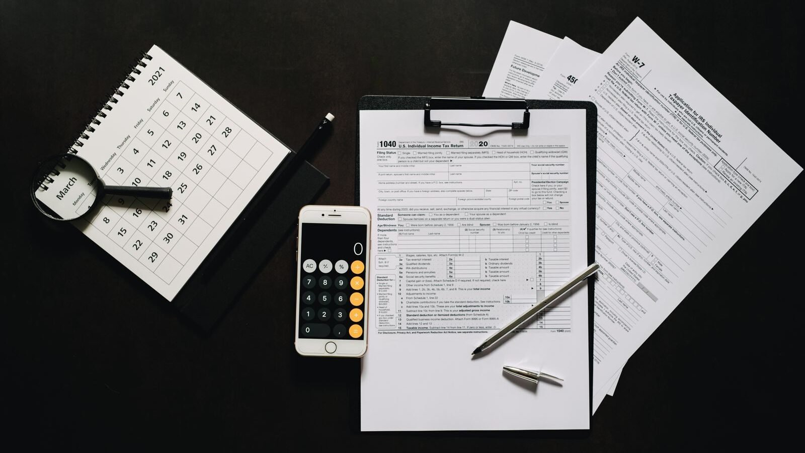 Reviewing nonprofit tax forms with a calculator and clipboard