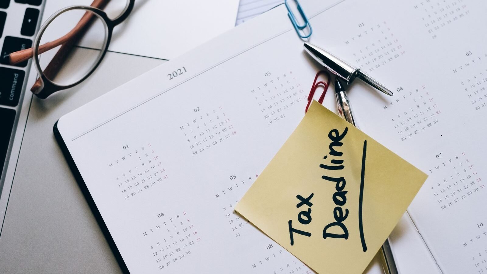 Tax deadline sticky note on a calendar page