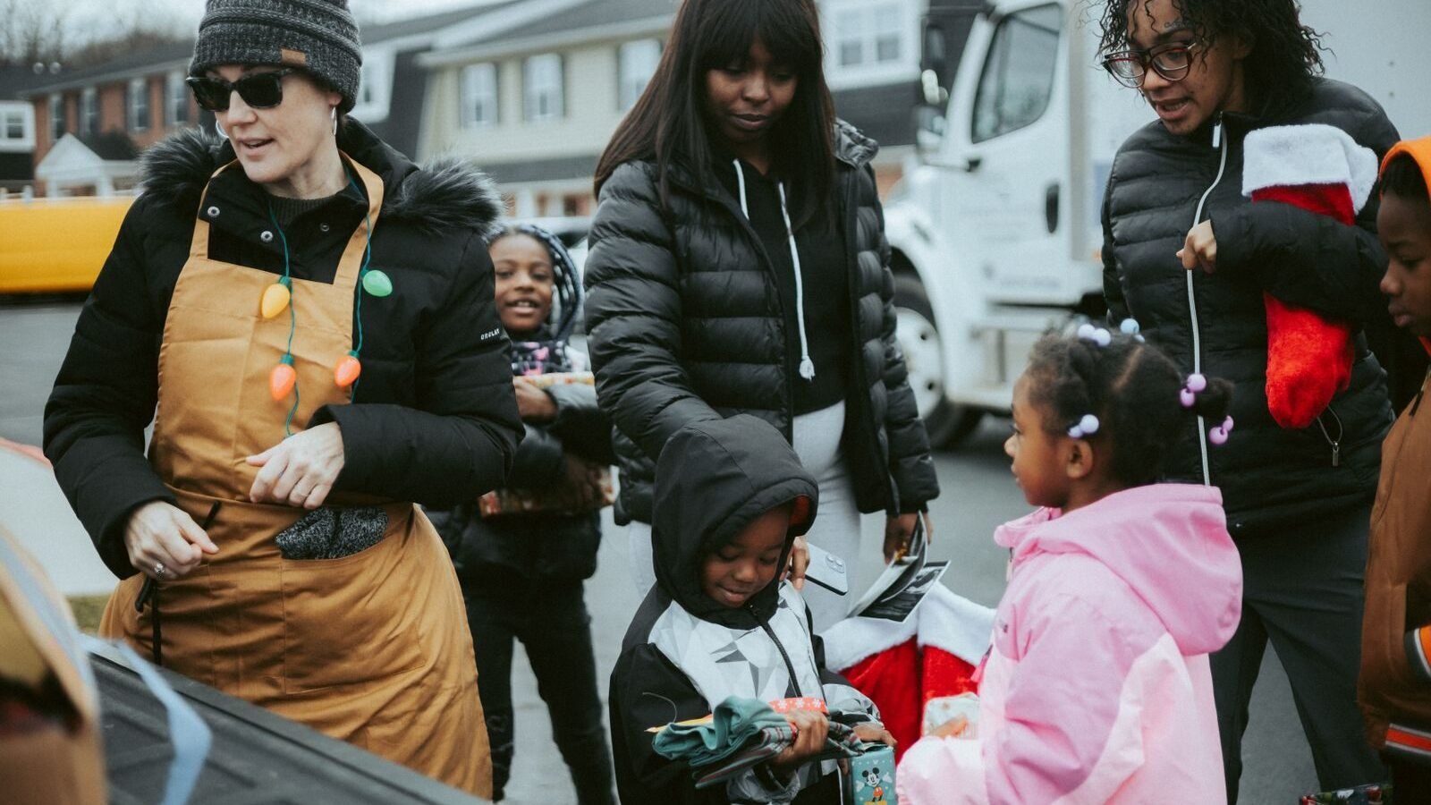 Community volunteers distributing gifts during year-end holiday giving